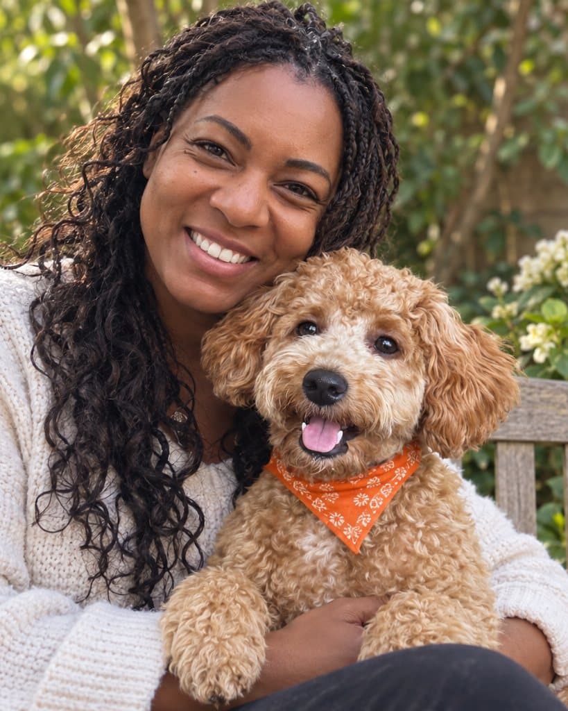 Sasha with Snoop on her lap on a garden bench